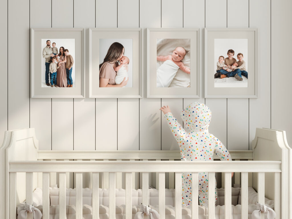 Image of a nursery with four framed prints above a crib.